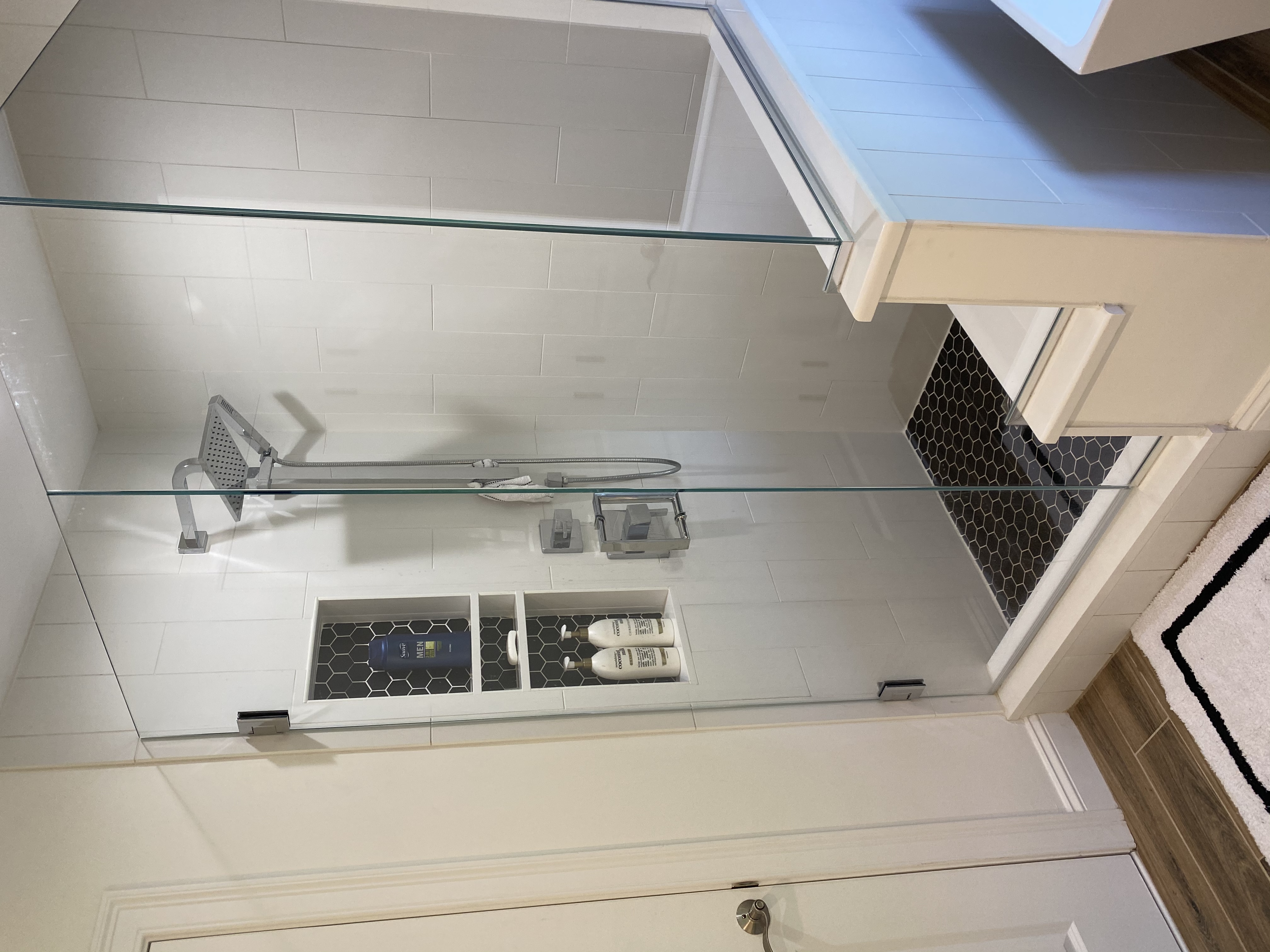 glass shower, black tile